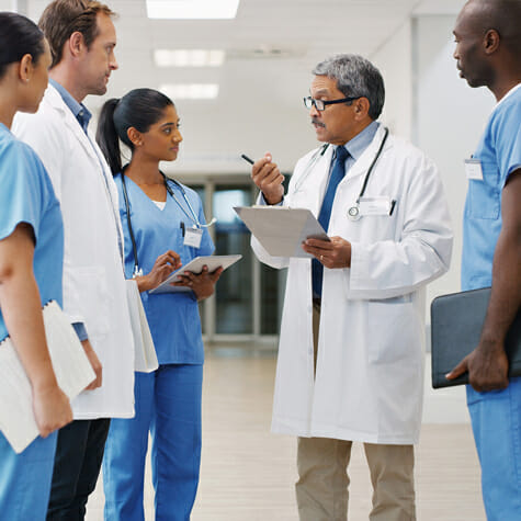 Doctor addressing clinical team in a medical setting
